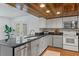 Bright kitchen with granite countertops, stainless steel appliances, and sliding doors to the patio at 7337 Glasgow Rd, Weeki Wachee, FL 34613