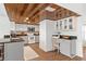 Well-lit kitchen with wood ceiling, white cabinets, granite counters, and stainless steel appliances at 7337 Glasgow Rd, Weeki Wachee, FL 34613