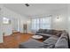 Cozy living room with large sectional sofa, bright windows, and hardwood-style flooring at 7337 Glasgow Rd, Weeki Wachee, FL 34613