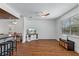 Open living area with hardwood-style floors, ceiling fan, and connecting dining and kitchen spaces at 7337 Glasgow Rd, Weeki Wachee, FL 34613