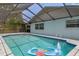 Inviting screened-in pool with clear water and ample space for relaxation and recreation at 7337 Glasgow Rd, Weeki Wachee, FL 34613