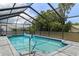 Screened-in pool featuring cool blue water, stone pavers, and an open view at 7337 Glasgow Rd, Weeki Wachee, FL 34613