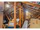 View of attic space with wooden beams and insulation, providing potential for storage at 7353 Dogwood Cres, Spring Hill, FL 34607