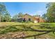 Scenic backyard view with lush greenery and a glimpse of the home's exterior showing a screened in porch at 7353 Dogwood Cres, Spring Hill, FL 34607