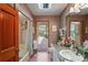 Bright bathroom featuring granite counters and a sliding glass door to the backyard at 7353 Dogwood Cres, Spring Hill, FL 34607
