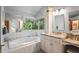 Luxurious primary bathroom suite with a large soaking tub and beautiful views at 7353 Dogwood Cres, Spring Hill, FL 34607