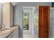 Well-lit bathroom with a tiled glass shower and marble countertops at 7353 Dogwood Cres, Spring Hill, FL 34607