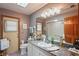 Bathroom with granite countertop, decorative mirror and a shower with glass door at 7353 Dogwood Cres, Spring Hill, FL 34607