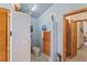 Charming bathroom with a bidet and decorative wooden saloon doors, and neutral tile floors at 7353 Dogwood Cres, Spring Hill, FL 34607