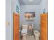 Bright bathroom featuring a bidet and toilet, artwork, and sconce lighting at 7353 Dogwood Cres, Spring Hill, FL 34607