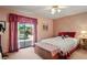 Bedroom with floral wallpaper and sliding glass door with a view of the backyard at 7353 Dogwood Cres, Spring Hill, FL 34607