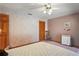 Bedroom with floral wallpaper, ceiling fan, wood closet door and overhead lighting at 7353 Dogwood Cres, Spring Hill, FL 34607