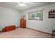 Well-lit bedroom with a window, wooden chest, and wall-mounted shelving at 7353 Dogwood Cres, Spring Hill, FL 34607