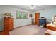 Cozy bedroom featuring a ceiling fan, window with a view, and wooden dresser at 7353 Dogwood Cres, Spring Hill, FL 34607