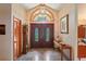 Elegant foyer with grand double doors, marble floors, and decorative lighting fixture at 7353 Dogwood Cres, Spring Hill, FL 34607