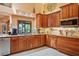 Charming kitchen with custom wood cabinets, granite countertops, and stainless steel appliances at 7353 Dogwood Cres, Spring Hill, FL 34607
