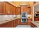 Updated kitchen with granite countertops, stainless steel appliances, and custom wood cabinets at 7353 Dogwood Cres, Spring Hill, FL 34607