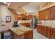 Spacious kitchen with granite countertops, wood cabinetry, and modern stainless steel appliances at 7353 Dogwood Cres, Spring Hill, FL 34607