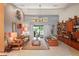 Bright living room featuring neutral walls, a ceiling fan, and sliding doors that bring the outdoors in at 7353 Dogwood Cres, Spring Hill, FL 34607