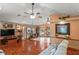 Living room features hardwood floors, a stone fireplace, and plenty of natural light at 7353 Dogwood Cres, Spring Hill, FL 34607