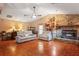 The living room features hardwood floors, a stone fireplace, and plenty of natural light at 7353 Dogwood Cres, Spring Hill, FL 34607