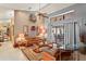 Bright living room featuring neutral walls, a ceiling fan, and sliding doors that bring the outdoors in at 7353 Dogwood Cres, Spring Hill, FL 34607