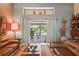 Bright living room featuring neutral walls, a ceiling fan, and sliding doors that bring the outdoors in at 7353 Dogwood Cres, Spring Hill, FL 34607
