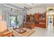 Bright living room featuring neutral walls, a ceiling fan, and sliding doors that bring the outdoors in at 7353 Dogwood Cres, Spring Hill, FL 34607