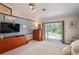 Spacious main bedroom featuring a ceiling fan, dresser, and view of the pool at 7353 Dogwood Cres, Spring Hill, FL 34607