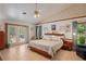 Comfortable main bedroom featuring a ceiling fan, en suite, neutral colors and natural light at 7353 Dogwood Cres, Spring Hill, FL 34607