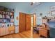 Home office featuring custom built-in bookshelves and a view of the bathroom at 7353 Dogwood Cres, Spring Hill, FL 34607