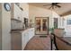 Outdoor kitchen features countertops, cabinets and a brick floor that leads to double doors into the home at 7353 Dogwood Cres, Spring Hill, FL 34607