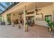 Outdoor patio showcasing brick flooring, ceiling fans, and plants that provide a relaxed atmosphere at 7353 Dogwood Cres, Spring Hill, FL 34607