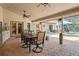 Spacious covered patio with brick flooring, ceiling fans, and outdoor furniture overlooking lush landscaping at 7353 Dogwood Cres, Spring Hill, FL 34607
