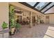 Covered patio featuring brick flooring, ceiling fans, plants, and furniture for outdoor enjoyment at 7353 Dogwood Cres, Spring Hill, FL 34607