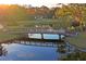 Scenic view of a pond with a wooden bridge reflecting in the calm water at 7353 Dogwood Cres, Spring Hill, FL 34607