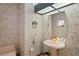Charming powder room featuring patterned wallpaper, a pedestal sink, and a skylight at 7353 Dogwood Cres, Spring Hill, FL 34607