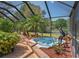 Relaxing spa area featuring tropical landscaping inside of a screened in pool area at 7353 Dogwood Cres, Spring Hill, FL 34607