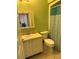 A basic bathroom with a vanity, toilet, and shower/tub combination with tile flooring at 7360 Ulmerton Rd # 20F, Largo, FL 33771
