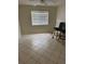 A bright and airy bedroom with a window with blinds, ceiling fan, and tile flooring at 7360 Ulmerton Rd # 20F, Largo, FL 33771
