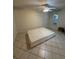 Spacious bedroom with tile floors, a ceiling fan, and two windows for natural light at 7360 Ulmerton Rd # 20F, Largo, FL 33771