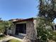 Charming single-story home with a brick facade, a screened-in porch, and mature landscaping at 7360 Ulmerton Rd # 20F, Largo, FL 33771