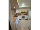 Well-lit kitchen features white appliances, ample cabinetry, and tile flooring for a clean and modern look at 7360 Ulmerton Rd # 20F, Largo, FL 33771