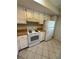 Kitchen features white cabinets, appliances, and tile flooring for a clean and modern look at 7360 Ulmerton Rd # 20F, Largo, FL 33771