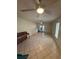 A spacious living room with tile flooring, ceiling fans, and natural light with double glass doors at 7360 Ulmerton Rd # 20F, Largo, FL 33771
