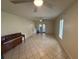A spacious living room with tile flooring, ceiling fans, and natural light with double glass doors at 7360 Ulmerton Rd # 20F, Largo, FL 33771