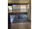 A covered outdoor patio with a tile floor, lattice privacy screen, and outdoor carpet at 7360 Ulmerton Rd # 20F, Largo, FL 33771