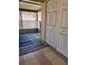 A covered outdoor patio with a tile floor, lattice privacy screen, and storage closet at 7360 Ulmerton Rd # 20F, Largo, FL 33771