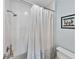 Shower with white tile and a decorative shower curtain at 7500 Sunshine Skyway S Ln # 201, St Petersburg, FL 33711