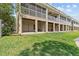 View of the manicured backyard with covered patio and screened-in porch at 800 Callista Cay Loop, Tarpon Springs, FL 34689